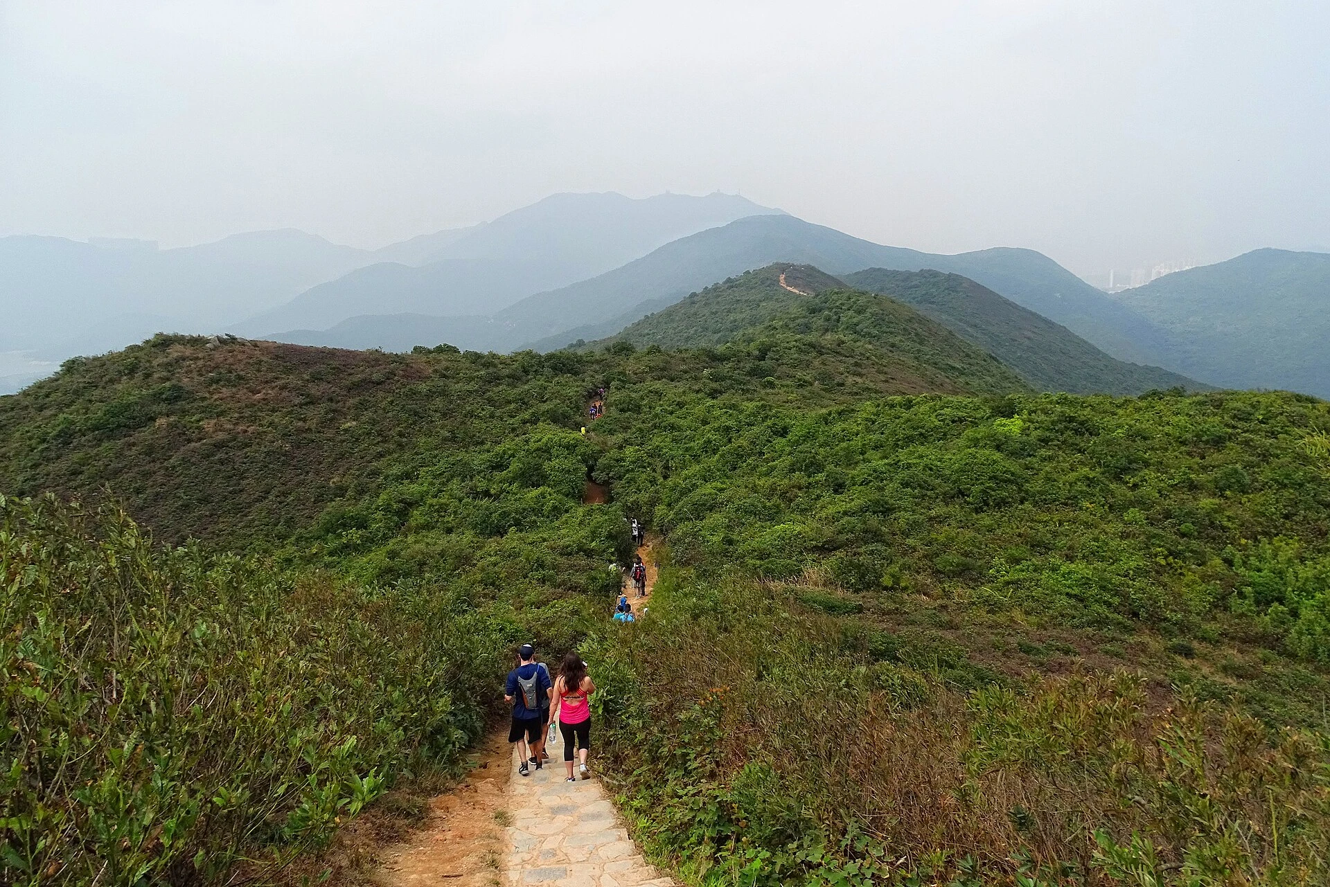 Hikers on the green Dragon’s Back ridge